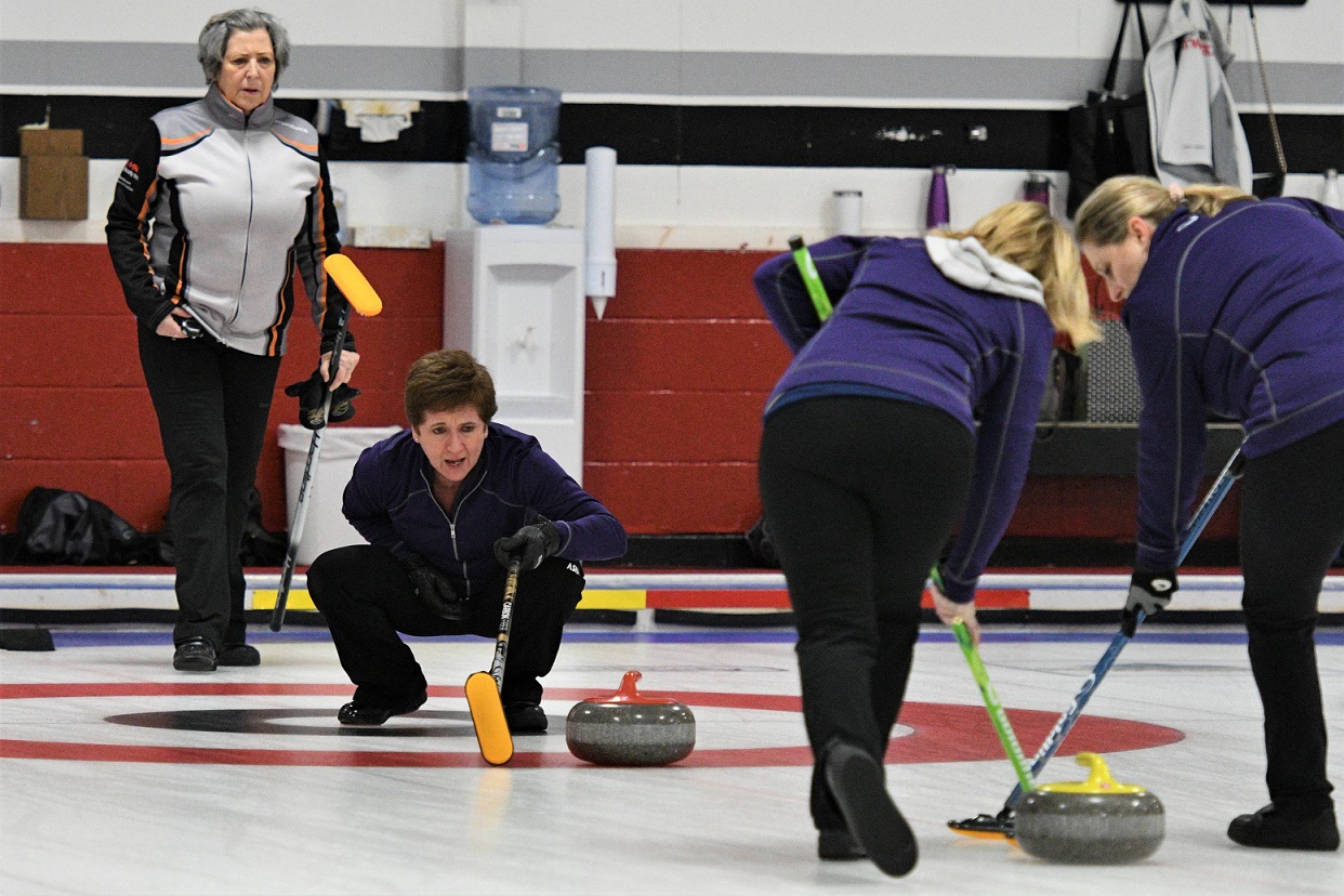 Cheryl McPherson watches her sweepers bring in the rock against the