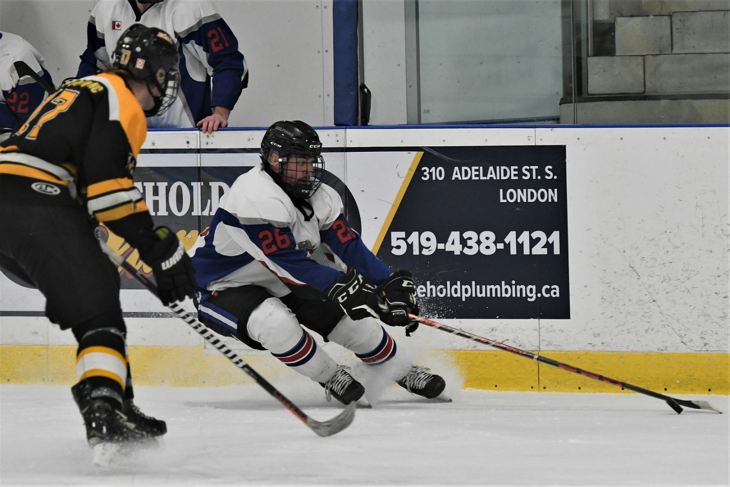 Dorchester Dolphin Jakob Marche (26) cuts back against Exeter Hawk Jack Robinson during PJHL action Sunday. Exeter won 4-2. <i> (photo / Rob J. Ross) </i> action