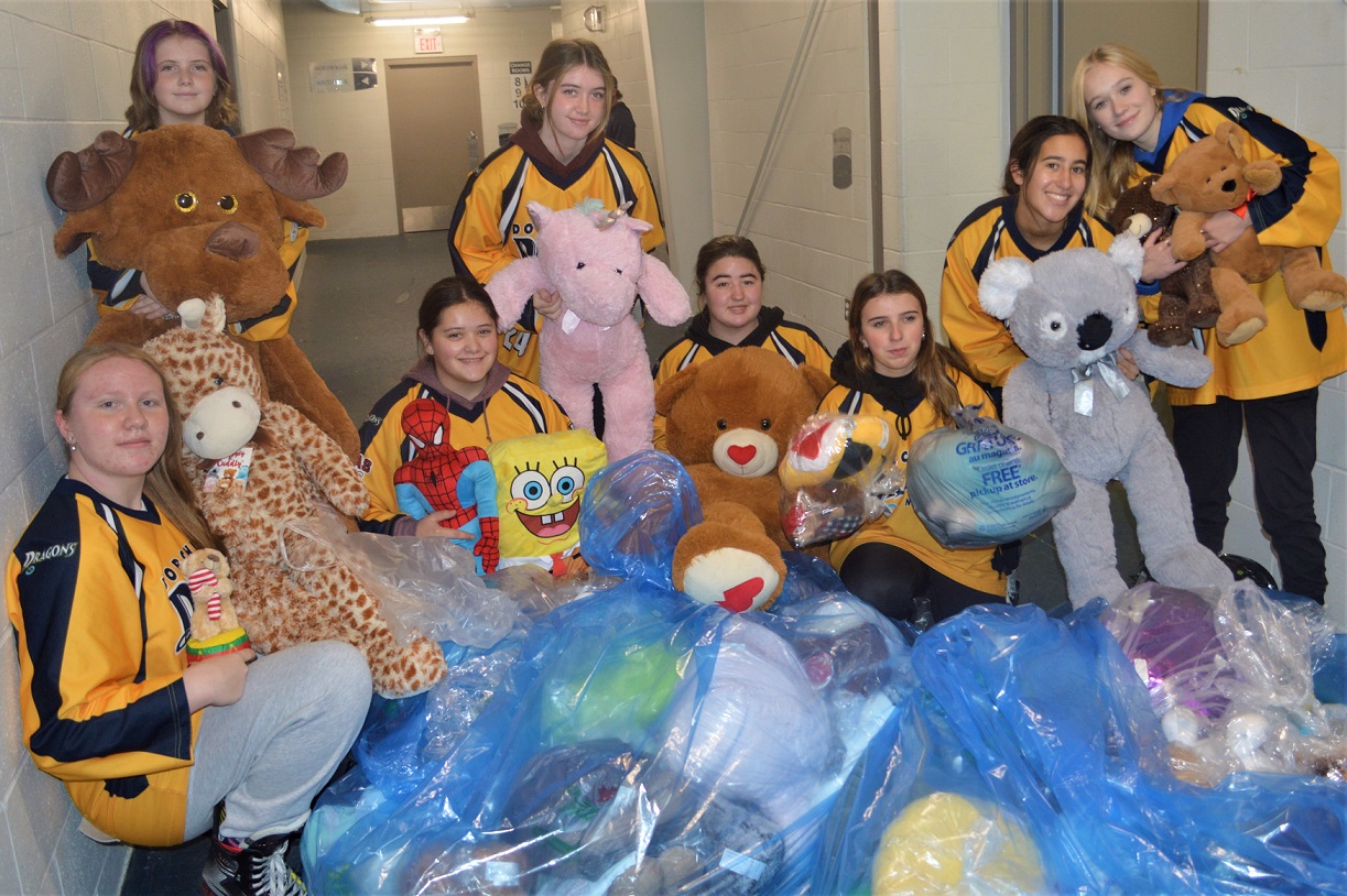 Dorchester Dragons U15 ringette team members show some of the stuffed animals collected at the Dorchester Dolphins' Teddy Bear Toss, Sunday, from left, Brielle Corbeil, Audrey Hendley, Mariza Coelho, Kaleigh Handley, Jadelynn Graves, Brooke Jackson, Mya Mendes and Ella Pusching. <i> (photo / Rob J. Ross) </i> action