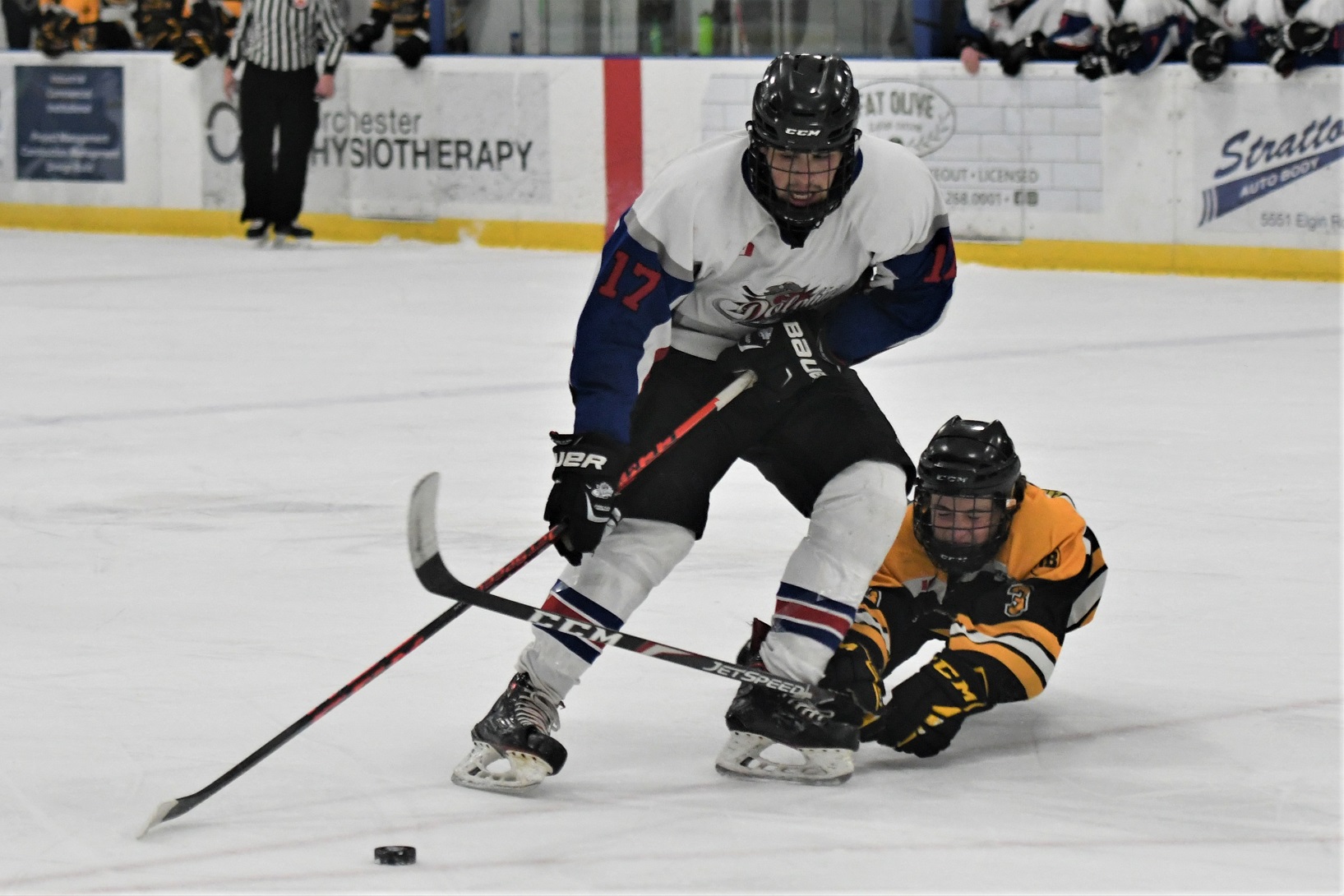 Dorchester Dolphin Josh Short drives in to the offensive zone while avoiding a diving Exeter Hawk Ryder Livermore during PJHL action Sunday. Exeter won 4-2. <i> (photo / Rob J. Ross) </i> action