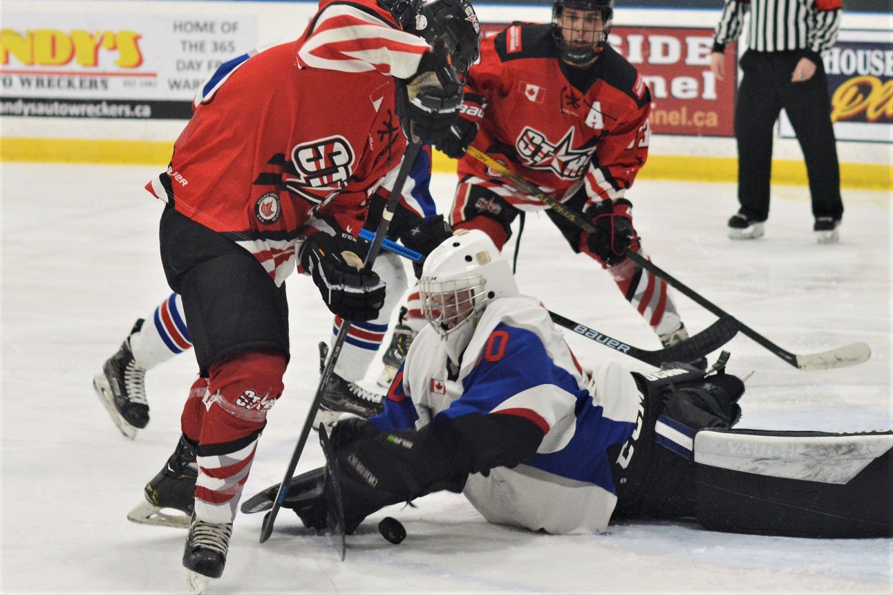 Dorchester Dolphins' goalie Jackson Mailloux jumps on the puck denying North Middlesex Star Harrison Rops, during PJHL action Wednesday at Dorchester. The Dolphins won 6-0.   <i> (photo / Rob J. Ross) </i> action