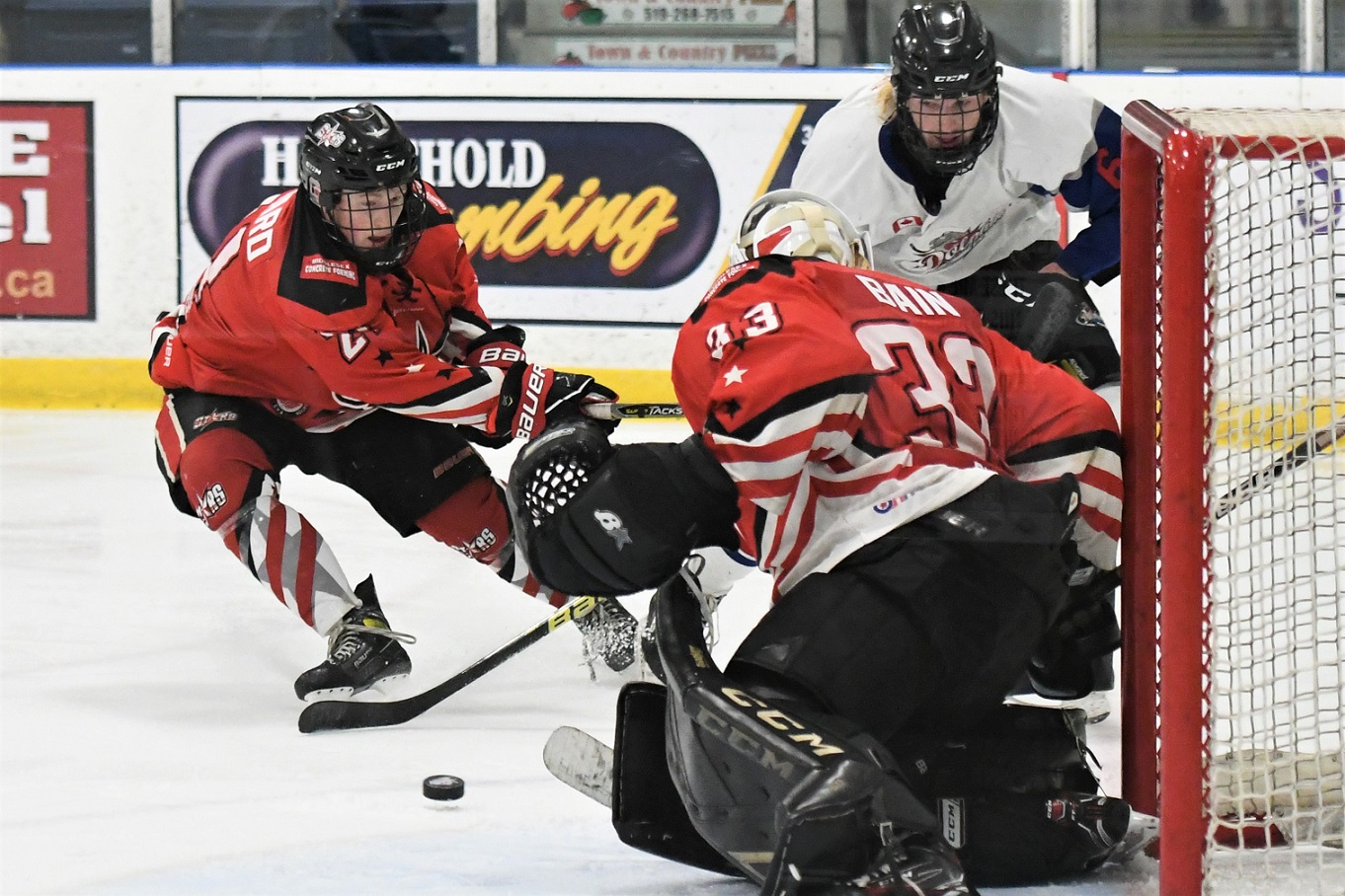 Dorchester Dolphin Brayden Smith (6) faces North Middlesex Stars' goalie Lucas Bain and defenceman Jacob Howard, battling for the puck during PJHL action Wednesday at Dorchester. The Dolphins won 6-0.   <i> (photo / Rob J. Ross) </i> action